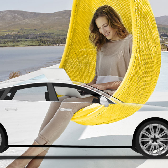 woman on laptop sitting with car